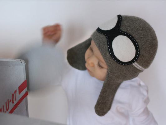boy with a grey aviator hat with black felted goggles