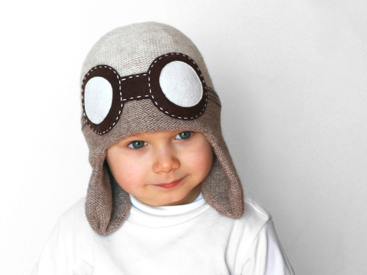 boy with a beige knitted aviator hat 