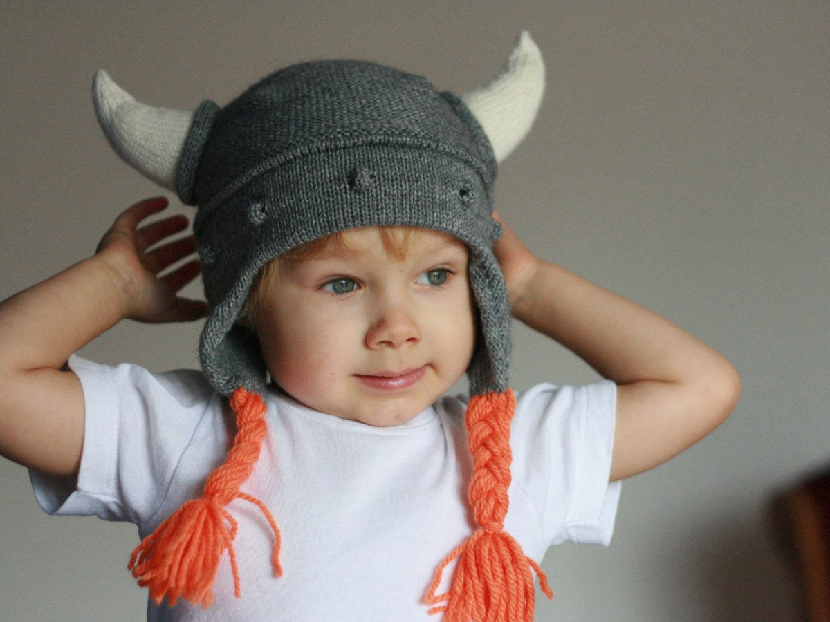 boy wearing a knitted grey viking hat